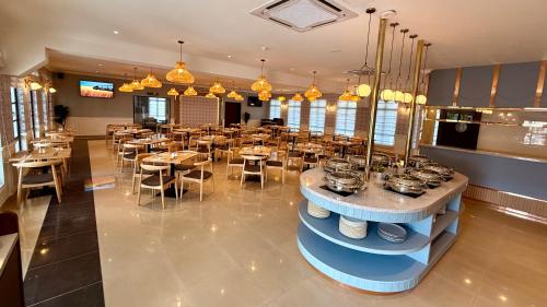 a dining room with tables and chairs in a restaurant at The Lisbon Melaka, Trademark Collection by Wyndham in Melaka