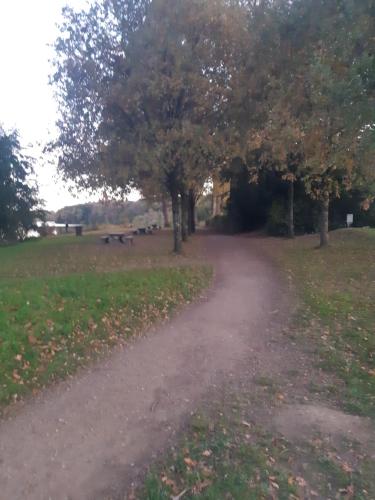 a dirt road in a field with trees at Beautiful cocooning appartement in La Chapelle-sur-Erdre