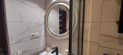 a bathroom with a mirror and a sink at Anna's centrum apt in Artemida
