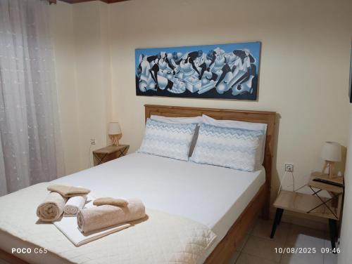 a bedroom with a bed with towels on it at Villa Karanti in Limenas