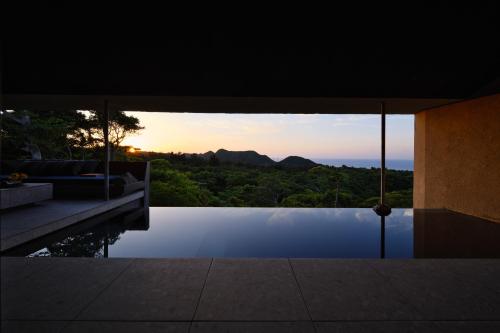 a view of the sunset from a house at AO NAKIJIN yanbaru terrace in Nakijin