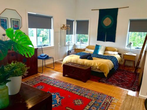a bedroom with a bed and a rug at The Seaside Studio Retreat in Wye River