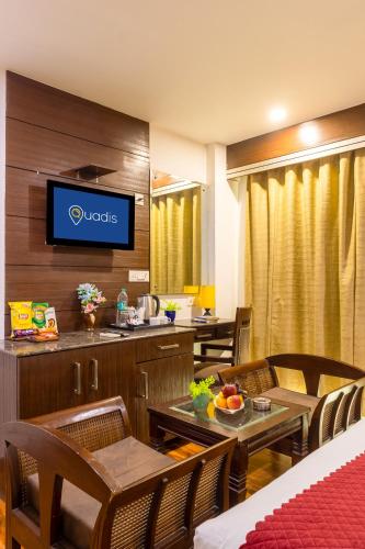 a hotel room with a restaurant with a buffet at Hotel Downtown - East of Kailash By Quadis in New Delhi