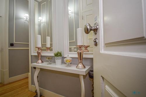 a bathroom with a table with candles and a mirror at B in B Douradores in Lisbon