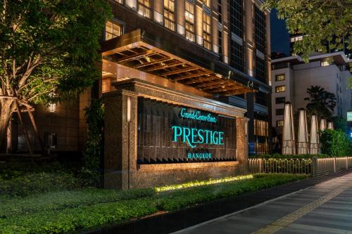 a sign on the side of a building at Grande Centre Point Prestige Bangkok in Bangkok