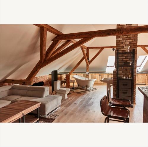 a living room with a couch and a table at Apartmány Pekárna 1898 in Beroun