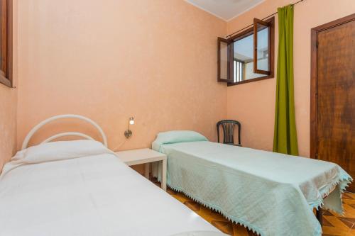 a hospital room with two beds and a window at A Casa Mia in Riposto