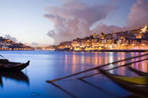 a view of a river with houses and a city at Porto's City Park & Surf Beach Rooms in Matosinhos