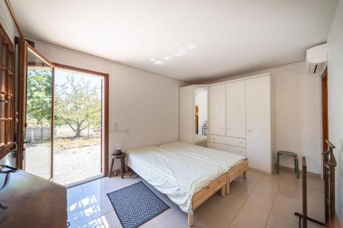 a bedroom with a bed and a large window at Charmante maison familiale Mandelieu-la-Napoule in Mandelieu-la-Napoule
