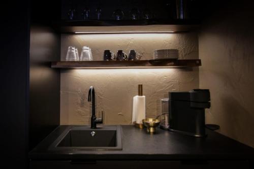 a kitchen counter with a sink and a coffee maker at Stylish City Suite in the Heart of Jyväskylä in Jyväskylä