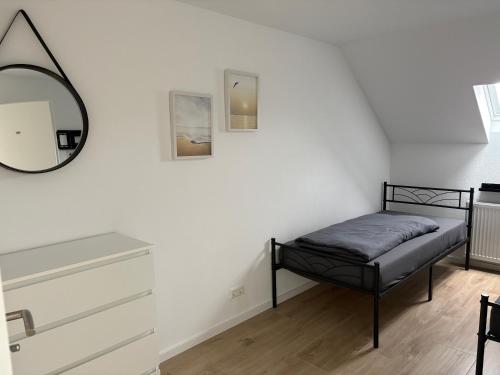 a bedroom with a bed and a mirror on the wall at RheinSchatz Apartments 3 in Oberwesel