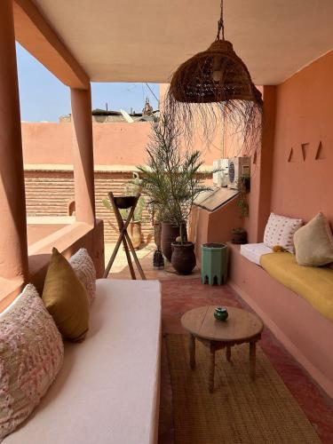 a living room with a couch and a table at Riad dar Maloukti in Marrakesh