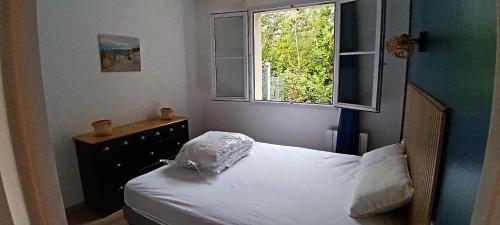 a small bedroom with a bed and a window at Notre Dame de Monts Entre mer et marais in Notre-Dame-de-Monts