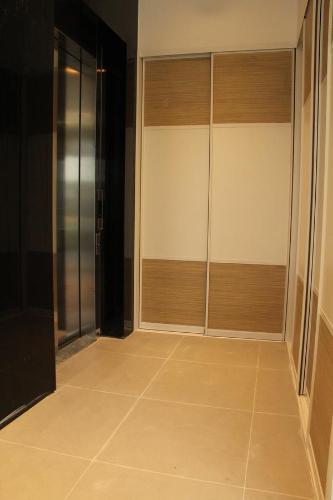 a hallway with glass doors and a tile floor at Hotel Grad in Sarajevo