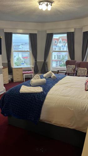 a bedroom with a large bed with pillows on it at The Great Western B&B in Paignton