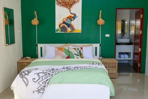 a bedroom with a bed with a green wall at Modern 2BR Pool Villa - Near Ao Nang Beach in Ao Nang 