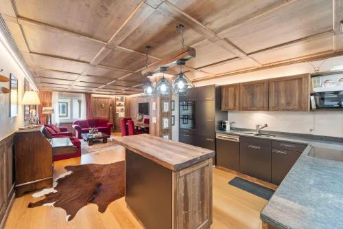 an open kitchen and living room with wooden ceilings at St Moritz Square 2 bedr Alpin Elegance in St. Moritz