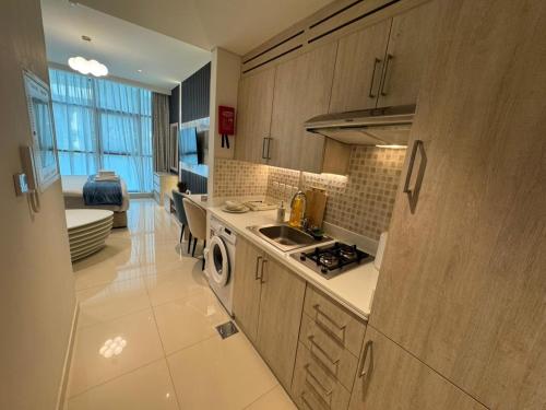 a kitchen with a sink and a stove top oven at Dubai Palm Jumeirah - Free Infiniti Pool and Private Beach in Dubai