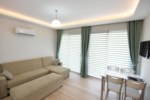 a living room with a couch and a table at Arti̇m Apart Hotel in Fethiye
