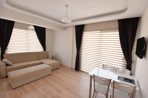 a living room with a couch and a table at Arti̇m Apart Hotel in Fethiye