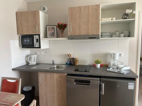 a kitchen with a sink and a counter top at Wattrelos Appart'S in Wattrelos