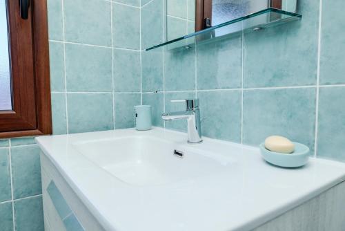 a bathroom with a sink with a bowl on it at Small paradise a few meters from the sea in Le Vecchie Saline