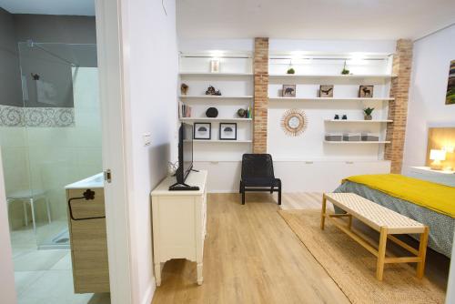a bedroom with a bed and a desk and a chair at Calderón de la Barca By Cuencaloft in Cuenca