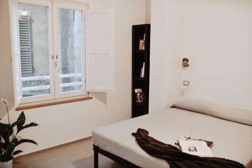 a bedroom with a bed and a window at Suite Grottabeach a due passi dal mare in Grottammare
