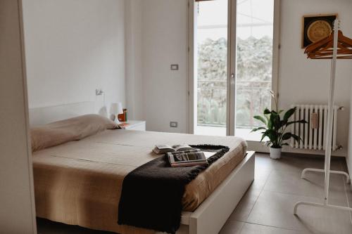 a bedroom with a bed and a large window at Suite Grottabeach a due passi dal mare in Grottammare