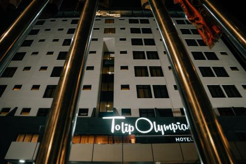 a hotel sign is seen on the side of a building at Tolip Olympia Hotel in Addis Ababa