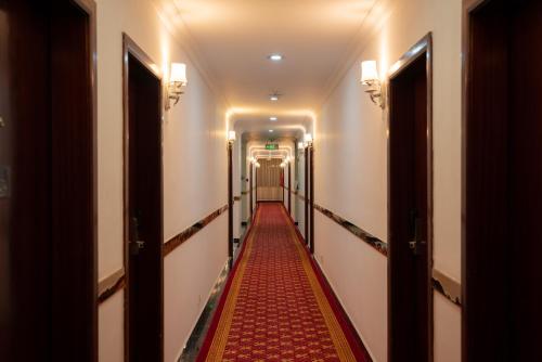 a long corridor with a red carpet in a hallway at Tolip Olympia Hotel in Addis Ababa