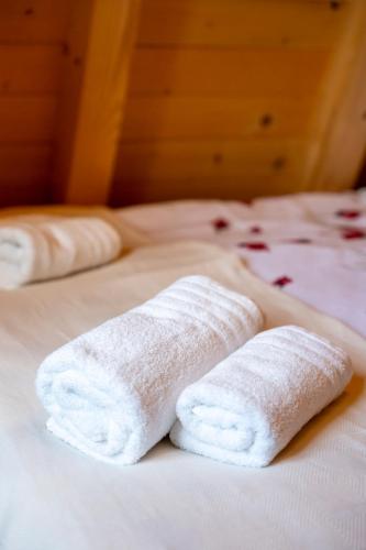 two white towels sitting on top of a bed at TheViewResort in Zlatibor