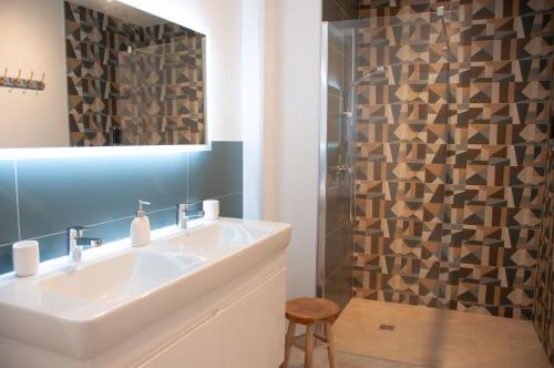 a bathroom with a sink and a shower at Duplex 6 personnes, vue panoramique sur lac in Malbuisson