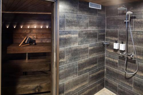 a bathroom with a shower with a glass door at Scandic Rovaniemi City in Rovaniemi