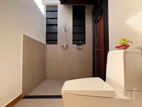 a bathroom with a toilet and a shower at MAKALA Pool Villa in Choeng Mon Beach