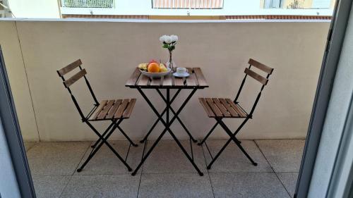 a table with two chairs and a bowl of fruit at Beautiful 43m2 with two double beds everything nearby in Nice