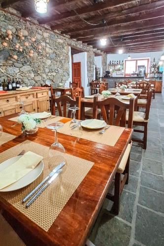 a dining room with wooden tables and wooden chairs at Hotel Rural Bentor in Los Realejos