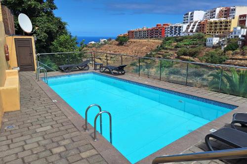 a swimming pool with a view of a city at Hotel Rural Bentor in Los Realejos