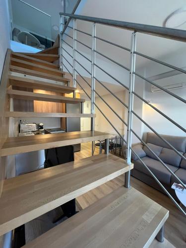 a staircase in a room with wooden shelves at A&R Atico Duplex Luxury II in San Sebastián de los Reyes