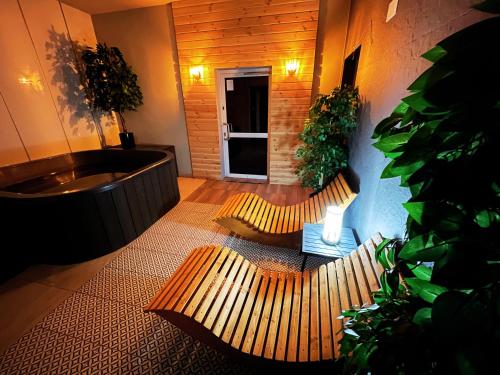 a bathroom with two benches and a bath tub at Good Night Noclegi & BSR Lipowska Strefa Relaksu in Czechowice-Dziedzice