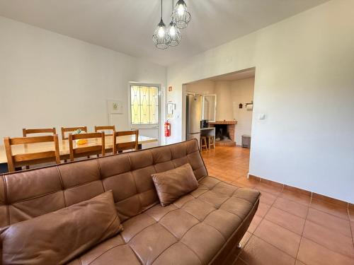 a living room with a couch and a dining room at WildValley Guesthouse in Braga