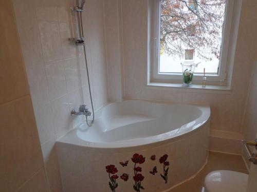 eine Badewanne im Bad mit Fenster in der Unterkunft Haus in der Nähe von Hannover Messe in Hannover
