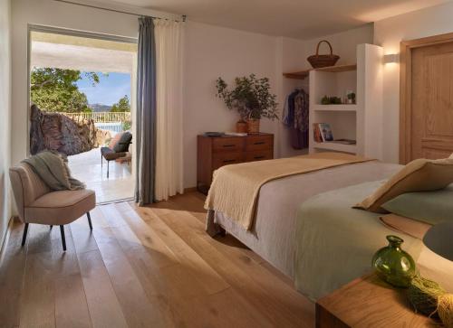 a bedroom with a bed and a sliding glass door at Cascioni Eco Retreat in Arzachena