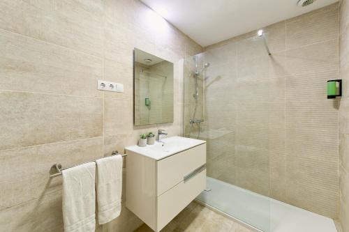 a bathroom with a sink and a shower at Alma de Pacifico in Málaga