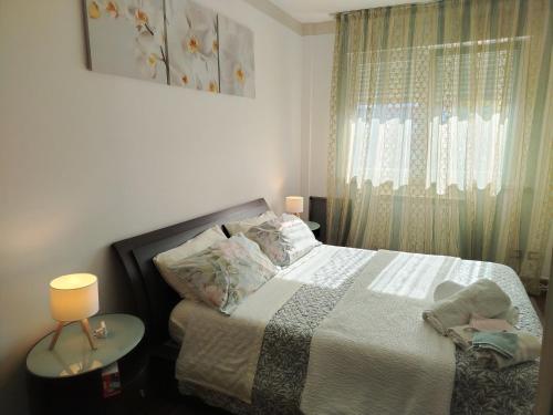 a bedroom with a bed and a window at Casa Malignani in Lunghezza