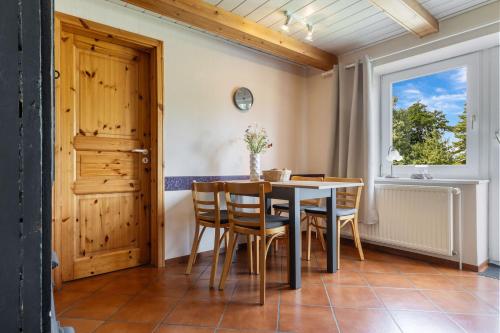 une salle à manger avec une table et des chaises et une fenêtre dans l'établissement Holunder, à Westermarkelsdorf