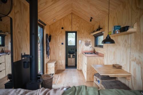 a kitchen and dining room of a tiny house at Ascella in Llanrwst