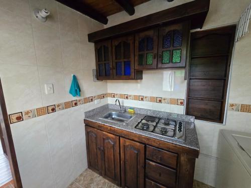 a kitchen with a sink and a stove at La Kama in Duitama