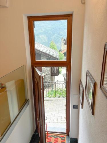 an open door to a balcony with a view at Il Capricorno in Châtillon