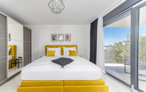 a bedroom with a large bed and a large window at Villa Karla with pool&sea view by Villas Guide in Rab